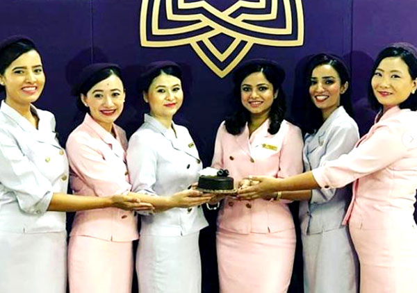 Group of girls holding a cake